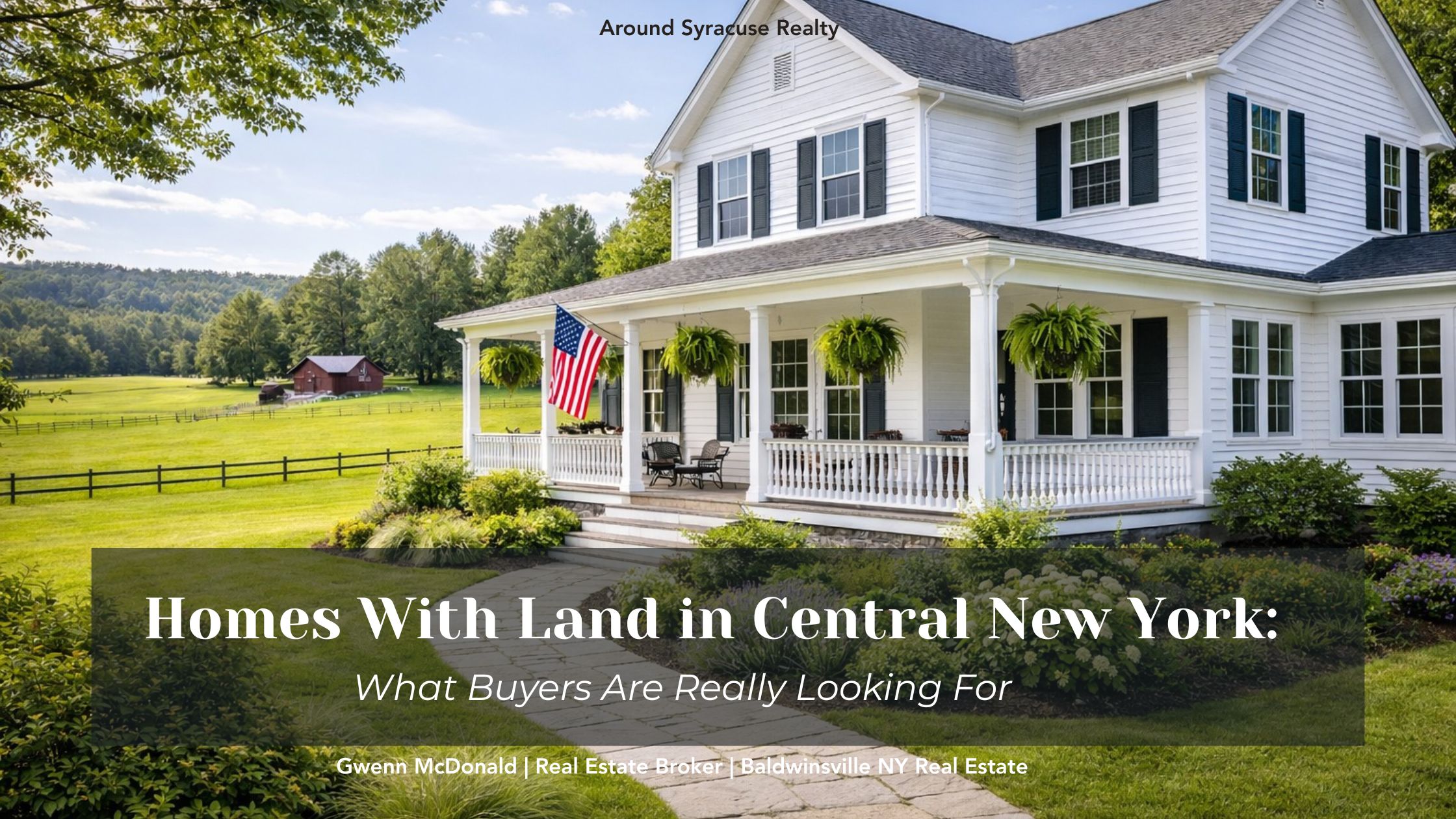 Well-maintained white farmhouse with wraparound porch, American flag, and open land in Central New York.